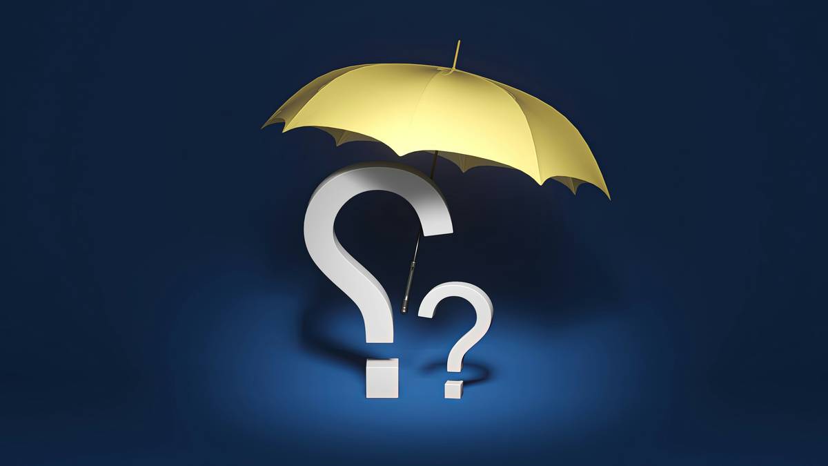 Publisher reviewing libel insurance publishing policy documents at desk