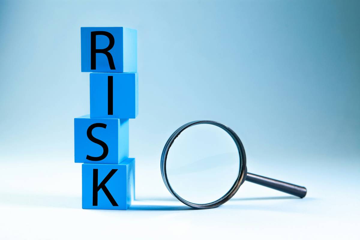 Author reviewing author risk insurance policy at desk