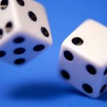 Rolling dice on blue.