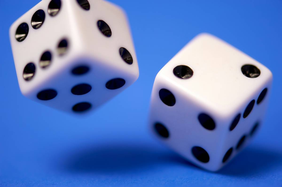 Rolling dice on blue.